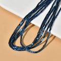 Macro shot of metallic blue triangular hematite spacer beads for DIY jewelry making - Blue