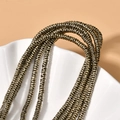 Macro detail of wave-shaped bronze spacer beads with textured finish for jewelry making - 260 Pieces/Pack / Grey Gold Wave Spacer