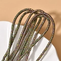 Detailed macro view of 4x1mm rainbow hematite wave beads for DIY jewelry making - 260 Pieces/Pack / Pink Green Wave Spacer