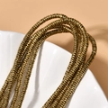Macro shot of 4x1mm gold-plated hematite wave disc spacer beads for jewelry making - 260 Pieces/Pack / Deep Gold Wave Spacer