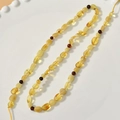 Detail of natural irregular amber beads with polished texture in a white ceramic tray - Small Natural Shape Amber Style (27#3*5mm)