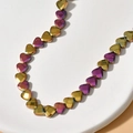 Macro shot of 6mm faceted heart-shaped beads with metallic gold and purple iridescent finish - 9# Pink Gold Faceted Heart (Approx. 70 Pcs/Strand)