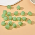 Light green raspberry glass beads for DIY jewelry making on pink background - Green Strawberry