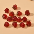 Detailed view of red raspberry glass beads with green leaves for DIY jewelry making - Red Strawberry