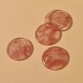 Close-up of four 30mm round pink marble texture resin charms with pre-drilled holes - Watermelon Crystal