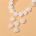 Detailed view of polished white heart-shaped natural stone beads for DIY jewelry making - White Jade Heart