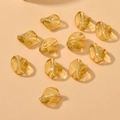 Close-up of amber yellow twisted irregular glass beads with straight holes for DIY jewelry - 1 Piece Pack / Light Burgundy Champagne