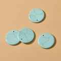 Detail of 30mm round blue turquoise stone pendants with golden veins and pre-drilled holes - Turquoise