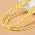 Macro detail of cylindrical yellow shell beads with a pearlescent silk luster finish - 3x5mm (Approx. 80 Beads/Strand) / Yellow