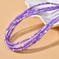 Dettaglio di perle cilindriche in madreperla viola con riflessi per gioielli - 3x5mm (Circa 80 perline/filo) / Viola