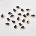 Detail of 14k gold-plated teardrop pendants with deep blue zircon and beaded edges - Dark Blue Drop