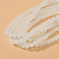 Detailed macro view of 8mm round translucent white glass beads for DIY jewelry making - White Jade