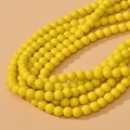 Detailed view of 8mm bright yellow glass beads with glossy finish for DIY jewelry making - Ceramic Yellow