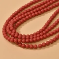 Close-up of 8mm round red glass beads with a glossy finish for DIY jewelry making - Red