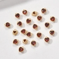 Detailed view of 14k gold-plated heart charms with red gemstones and beaded texture - Red Zircon Heart
