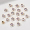 Detailed macro of 14k gold heart charm pendants with faceted lavender zircon stones - Light Purple Zirconia Heart