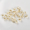 Macro view of clear silicone and 18k gold-plated ear backings for earring making - Gold 5.5mm