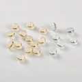 Close-up of silicone and 18k gold plated flying saucer earring backs for DIY jewelry making - Milky White Gold 6mm