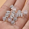 18k gold plated transparent silicone earring backs displayed on hand for size - Platinum Color 7mm