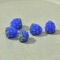 Macro view of blue berry glass beads with green leaves for DIY jewelry making - Dark Blue Raspberry