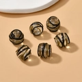 Macro detail of 13mm handmade glass beads with gold glitter and black spiral patterns - Black (6#)