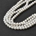Macro shot of white imitation cotton pearls with matte texture for DIY jewelry making - 6mm (Approx 75 Beads)