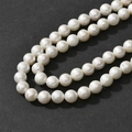 Detailed macro view of cream white cotton pearl beads with unique matte textured finish - 8mm (Approx 45 Beads)