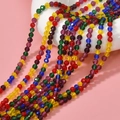 Macro shot of 3mm faceted colorful glass rondelle beads for DIY jewelry making - Purple Yellow Blue Mixed Transparent