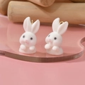 Close-up of white flocked rabbit pendants with golden metal loops for DIY jewelry - 12# Naughty Rabbit (13x28mm)