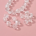 Macro shot of translucent glass beads with white star patterns for DIY jewelry making - Snowflake Beads