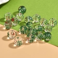 DIY glass beads for jewelry making with festive red and white dots on green leaf pattern - Christmas Tree Round Bead