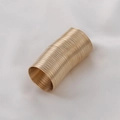 Macro shot of gold spiral memory wire cylinder for DIY beaded ring jewelry making - Gold