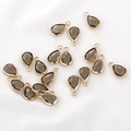 Detailed close-up of teardrop smoky brown crystal pendants with gold metal frames for DIY jewelry - 1 Piece / Olive Green
