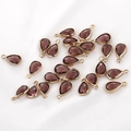 Macro view of teardrop purple crystal pendants with gold edges for jewelry making - 1 Piece / Coffee