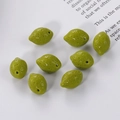 Macro shot of eight green resin lemon charms with side holes for DIY jewelry making - Bright Lime Green