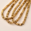 Macro detail of golden hematite square spacer beads for DIY jewelry making chains - 4x4mm (Approx. 390 Pieces) / Gold