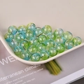 Close-up of hollow glass beads with blue and green gradient and spiral swirl texture - Blue Green Gradient Swirl (15# Gradient Blue Green)