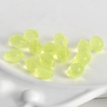 Translucent yellow resin lemon charms for DIY jewelry making on white tray - Bright Translucent Lime Green