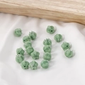 Macro shot of light green glass flower beads with white marbling for DIY jewelry making - 1 Piece / Green