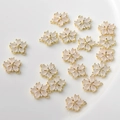 Detailed view of cherry blossom pendants with pink petals and gold plated metal settings - White Flower (15#)