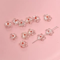Macro detail of transparent glass flower beads with orange centers for DIY jewelry making - Flower