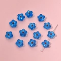Macro view of blue translucent glass flower beads with red centers for DIY jewelry making - Flower