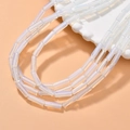 Translucent iridescent cylinder tube beads for jewelry making on a decorative white tray - 31# Opal
