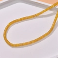 Detail of yellow cylinder stone beads on a white tray for DIY jewelry making - Yellow Orange Style (35#)