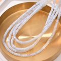 Macro shot of white synthetic opal cube beads on a gold tray for DIY jewelry making - Opal Style (5#)