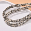 Macro view of cylindrical Dalmatian Jasper beads on a white minimalist display tray - Dalmatian Jasper Style (6#)