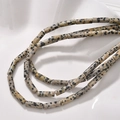 Macro shot of Dalmatian Jasper cylinder beads with black spots for DIY jewelry - 24# Dalmatian Jasper