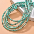 Macro shot of turquoise Heishi cylinder beads with natural marble texture for DIY jewelry - Turquoise Style (21#)