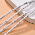 Macro detail of white marble patterned heishi beads strings for DIY jewelry making - White Turquoise Synthetic Style (22#)
