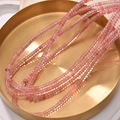 Macro view of translucent pink cube beads on a brushed gold tray for jewelry making - Watermelon Crystal Style (23#)